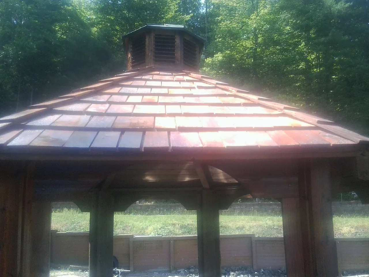 New cedar shake roof and cupola on a lakeside gazebo in Stella