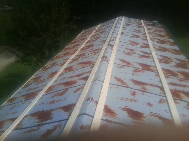 Rusted metal roof panels with new wood purlins before replacement — Storm Damage Roof Repair in Stella by Roofing Brothers